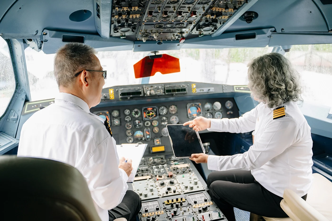Man and woman pilots in an airplane cockpit